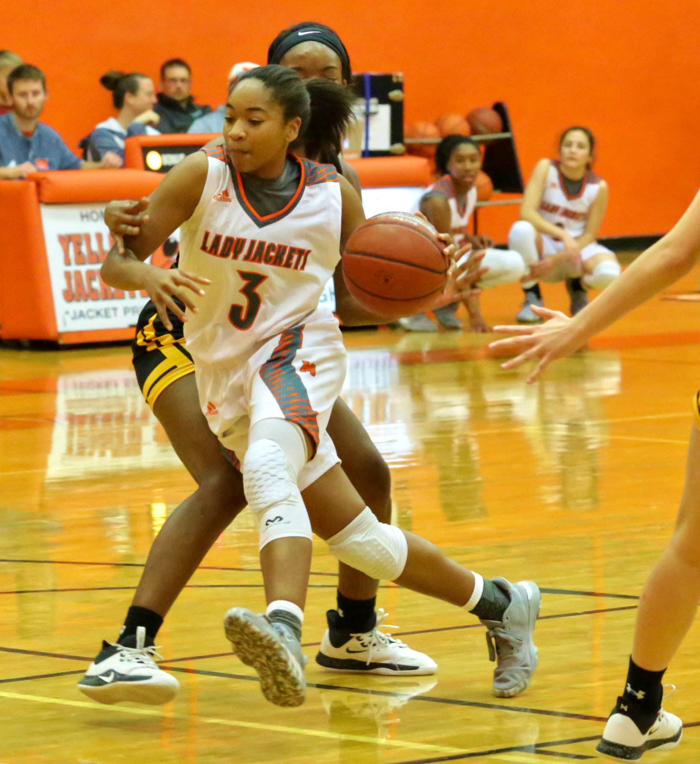 Lady Jacket Sabria Dean drives the lane before dealing an assist to teammate Kelsey Brewington.
